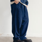 INDIGO DYED RELAXED PLEATED TROUSERS